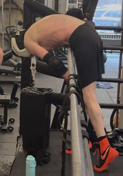The prospective opponent vomiting over the ring ropes